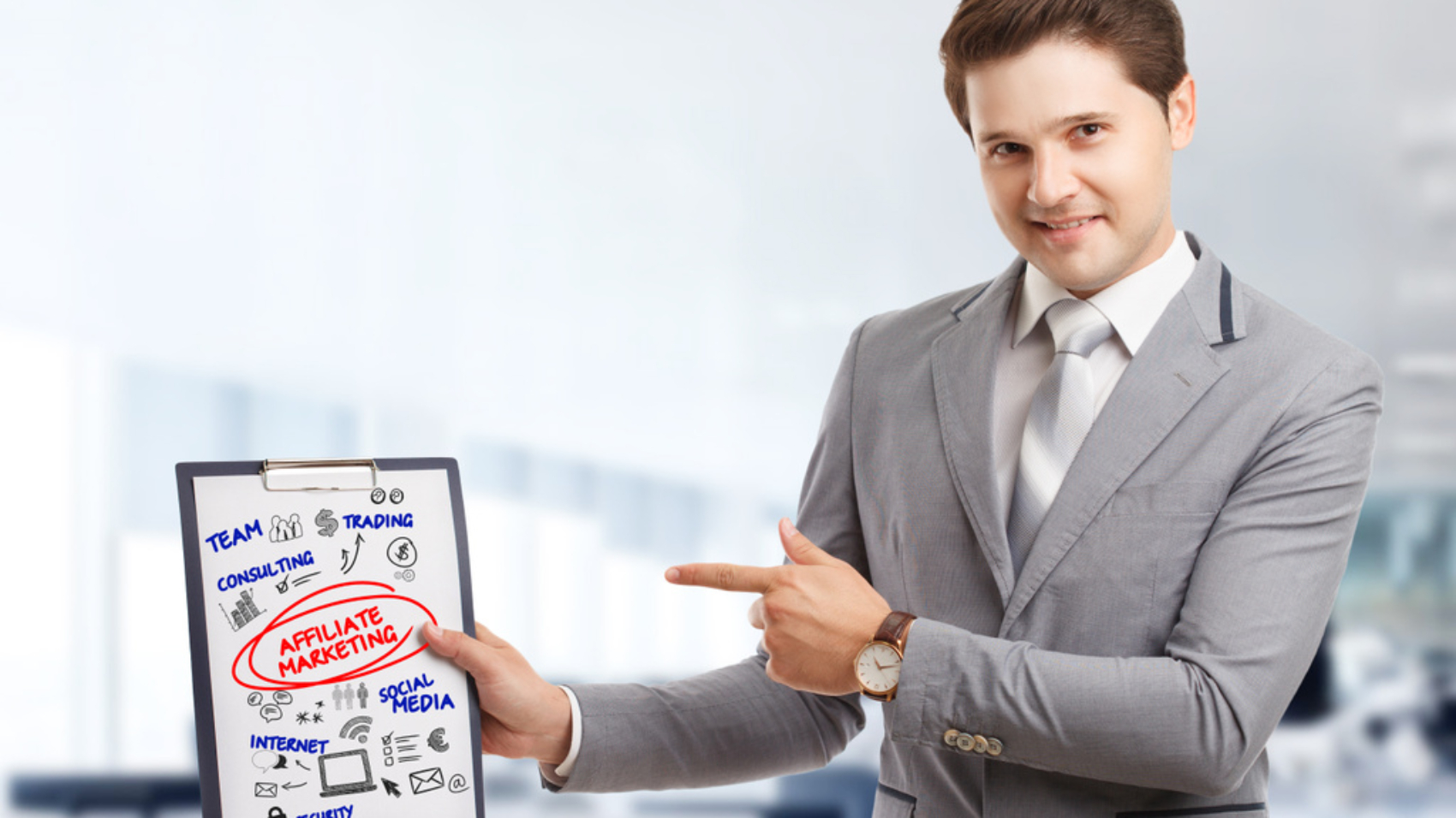 Planning marketing strategy. Business, Technology, Internet and network concept. Young businessman shows the word: Affiliate marketing